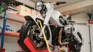 Fixing Custom motorcycle standing in repair shop. Instruments and equipment. Hobbies and unique Jobs