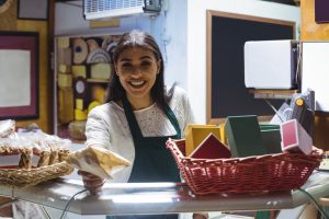 Waitress giving parcel at counter in cafe