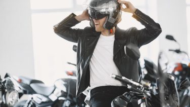 Handsome man choosing a motorcycle to buy
