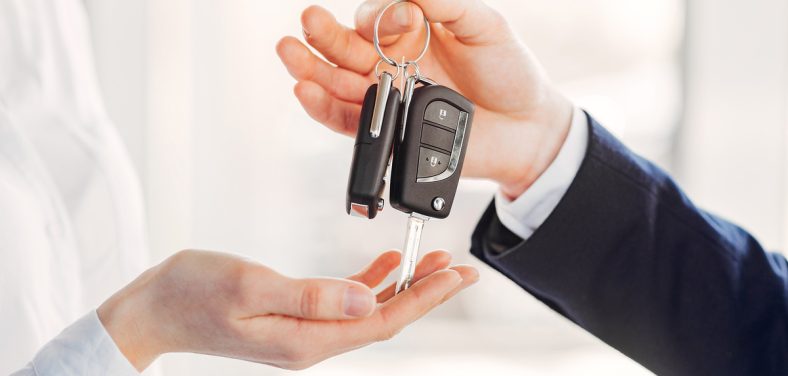 Woman buying the car. Lady in a car salon. Manager with a client